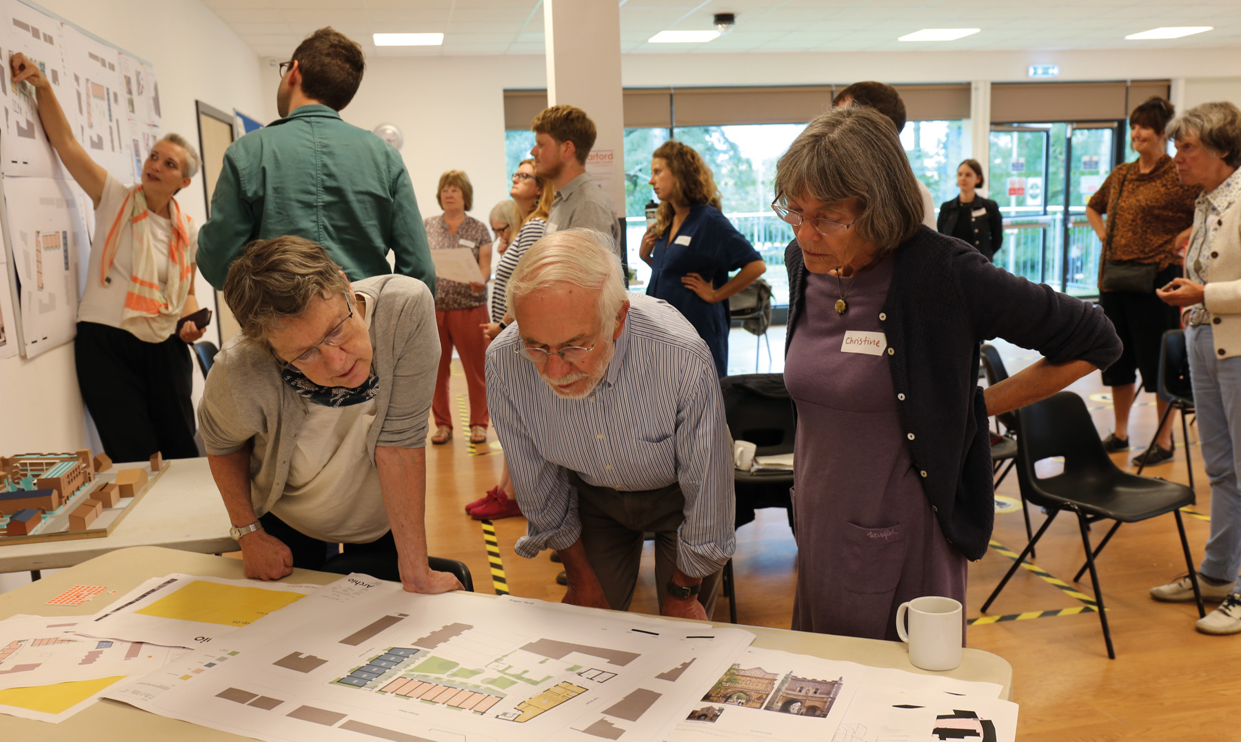 Angel Yard cohousing group members looking at plans at a design workshop