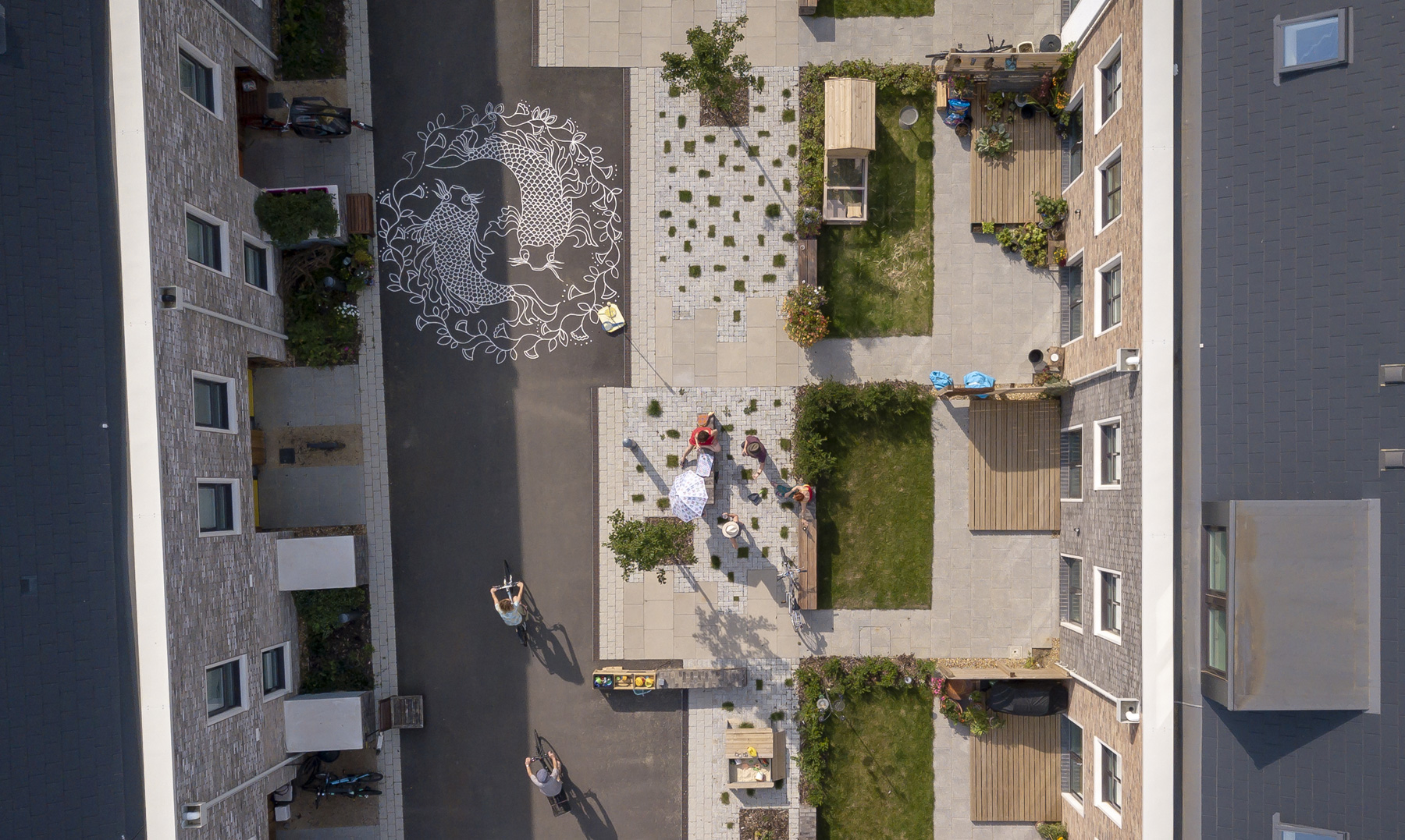 Aerial of Marmalade lane showing cyclists and children playing