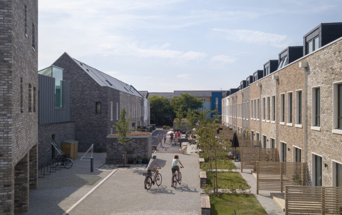 Street view of Marmalade Lane with people riding bikes in the foreground