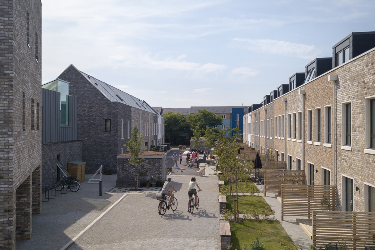 Street view of Marmalade Lane with people riding bikes in the foreground