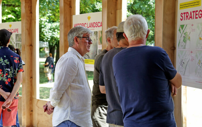 People viewing the Moulsecoomb Place plans at an engagement event inside the Riwaq