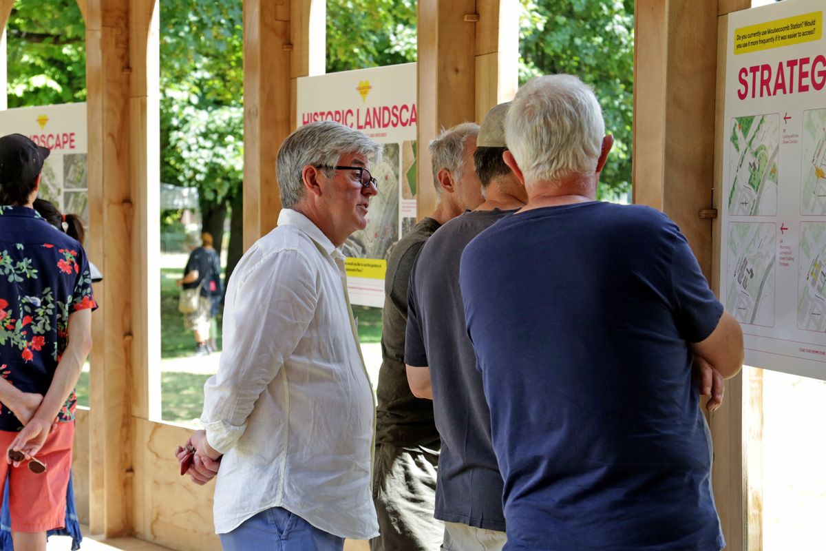 People viewing the Moulsecoomb Place plans at an engagement event inside the Riwaq