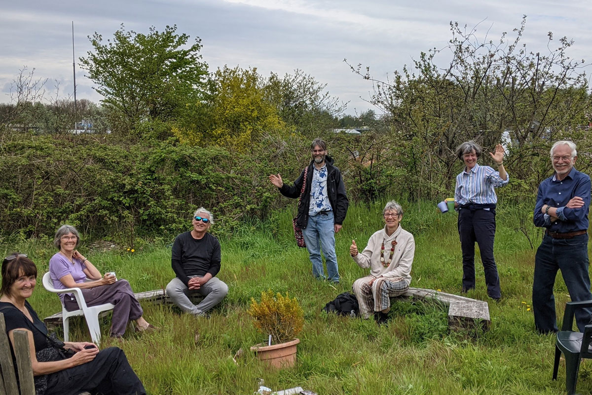 Angel Yard Cohousing Group sat outside in a grassy area